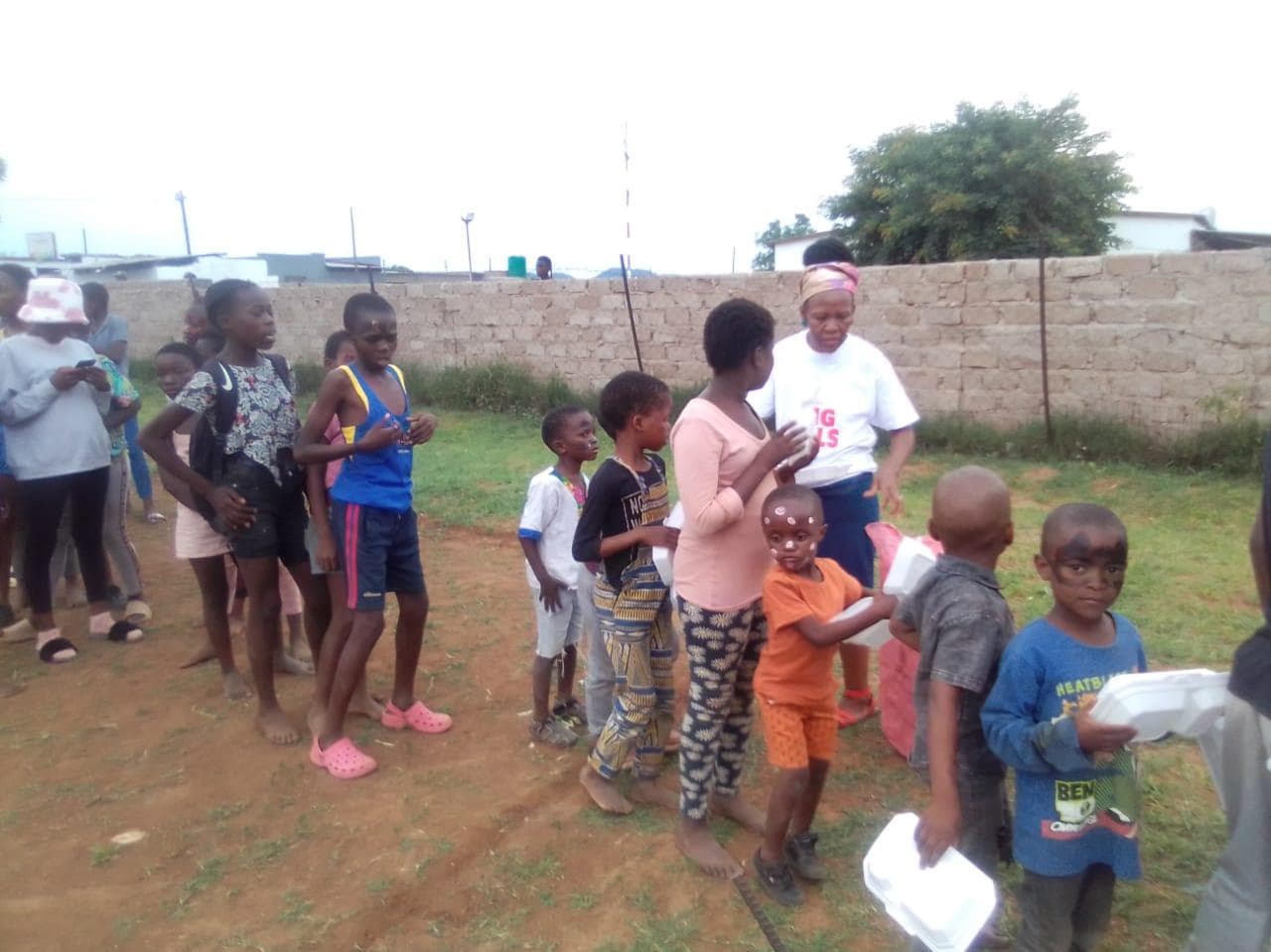 Children receiving support during a SHUTWWEP community programme
