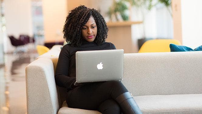 Woman working on a laptop in a professional setting
