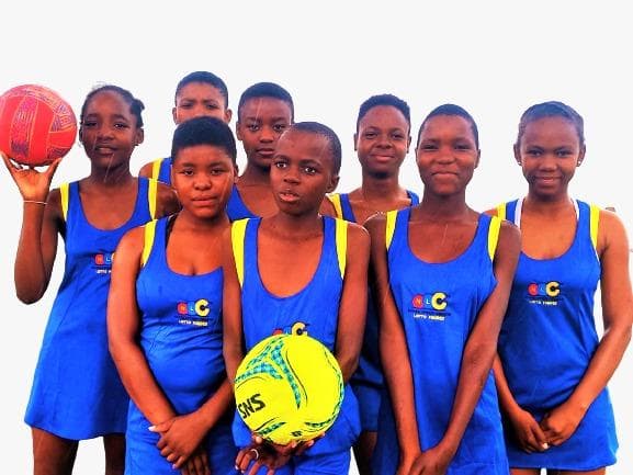 Youth sports team standing together in netball uniforms