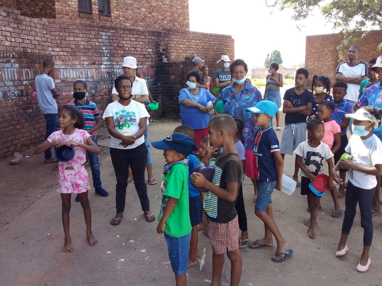 Children and adults gathered during a community outreach activity
